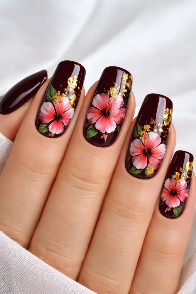 Hibiscus nails with gold foil accents luxe tropical floral design