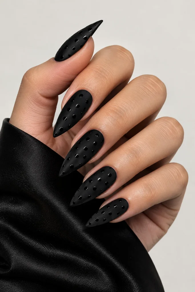 Matte black almond nails with subtle glossy black dots