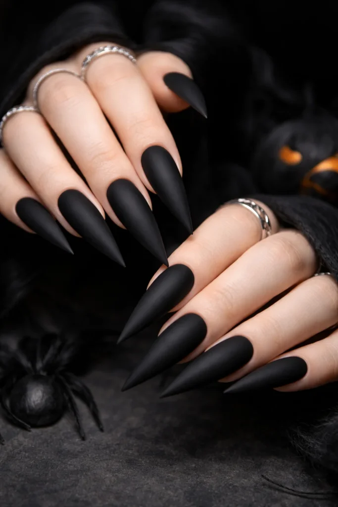  Sleek matte black Halloween nails on coffin shape 
