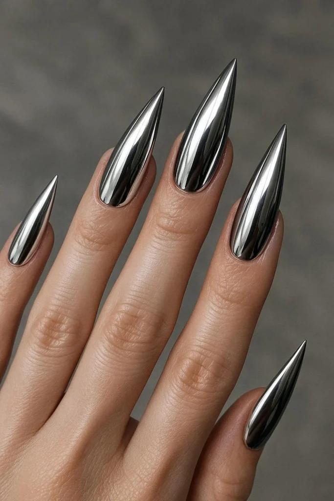  Metallic silver chrome stiletto nails with futuristic mirror finish 
