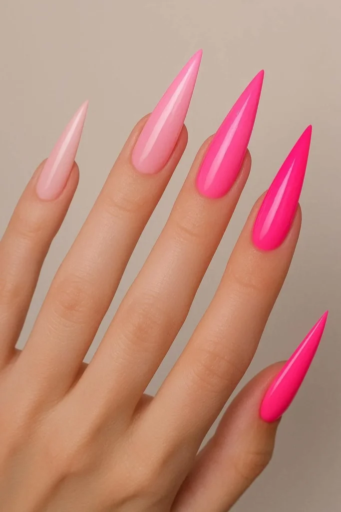 Pink stiletto nails ranging from soft blush to hot pink 
