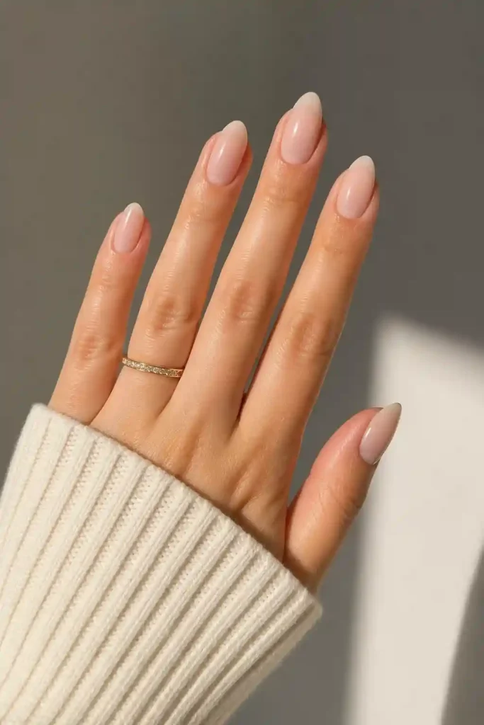 Short almond nails with soft rounded shape and sheer polish