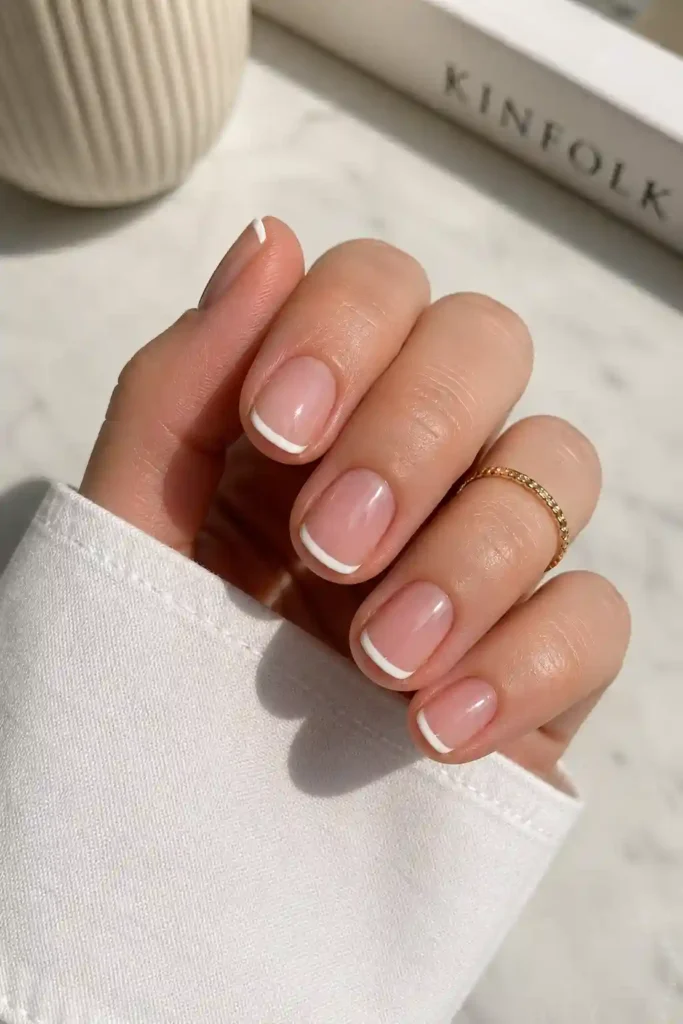Short French tip nails with thin neat white tips
