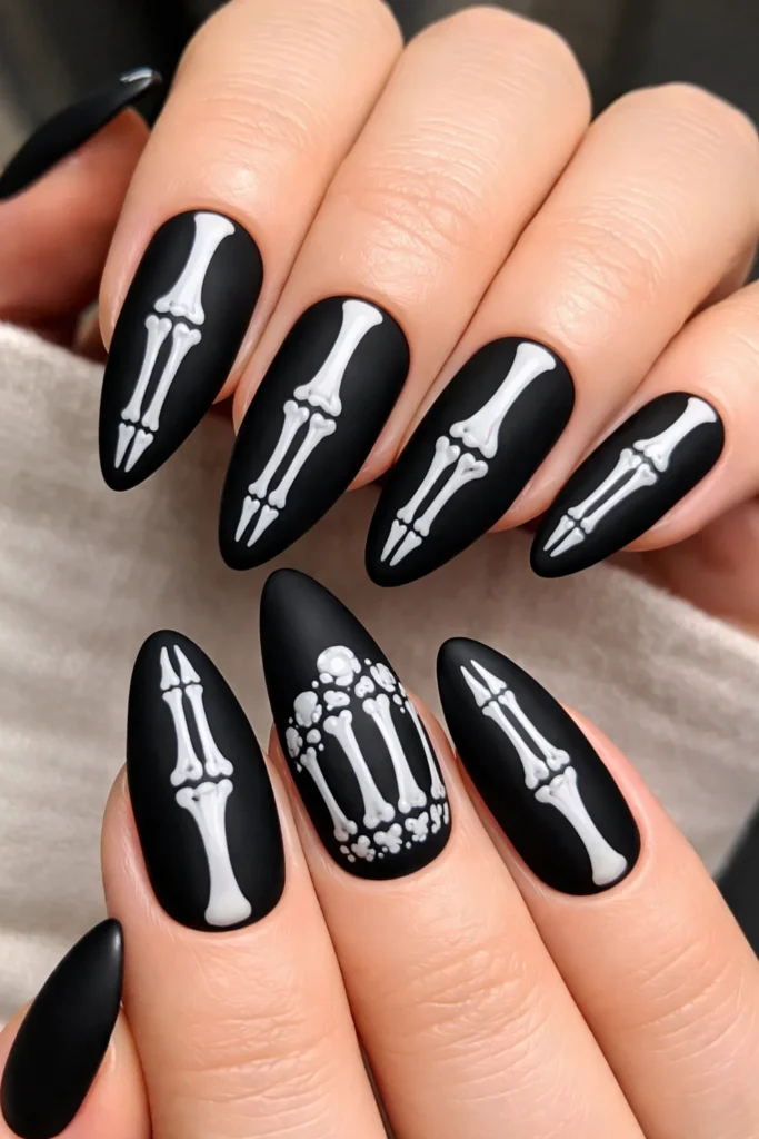 Minimal white skeleton bone nail art on black nails