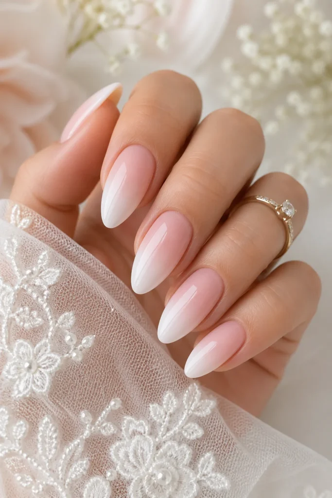 Soft pink to white ombre bridal nails gradient design