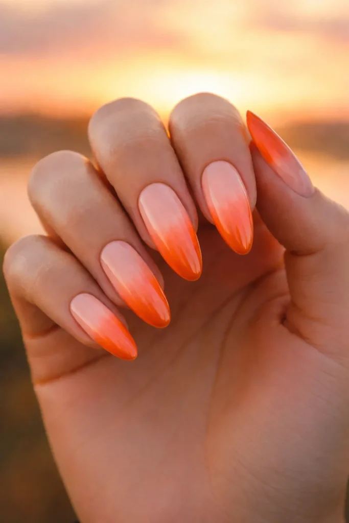 Sunset ombre nails in orange pink and nude
