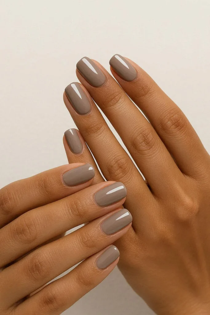 Taupe minimal nails with a clean glossy finish
