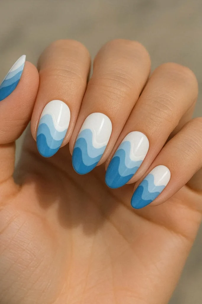 Wave pattern beach nail ideas in white and blue coastal design