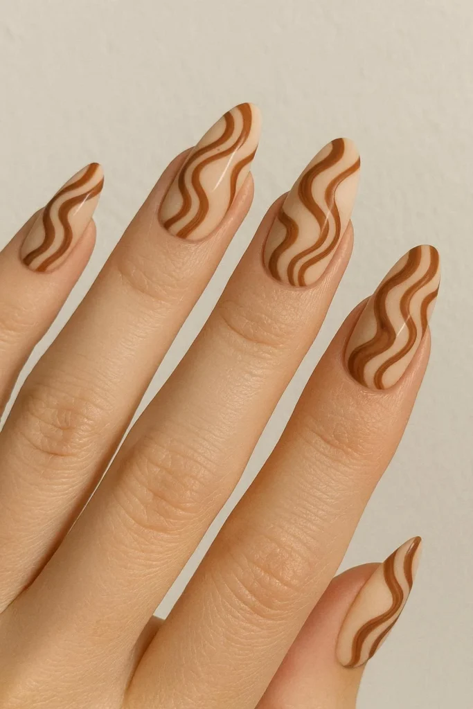 Western swirl nails in brown and cream inspired by desert sand 