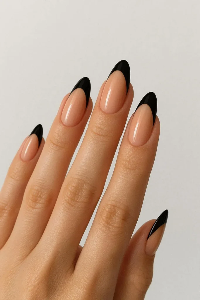 Almond shaped black French manicure with nude base