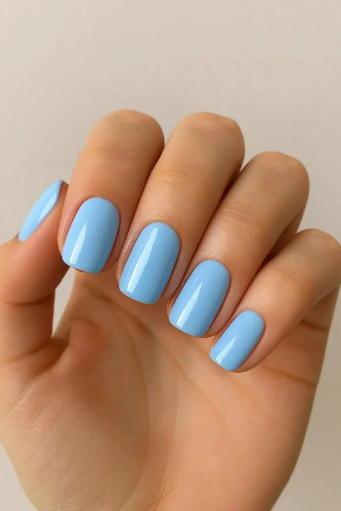 Baby blue nails in a soft calm shade with glossy finish 