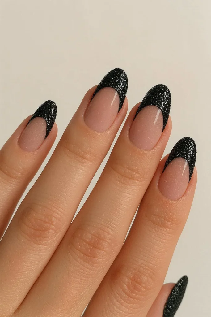 Black glitter French tip nails sparkling on nude base