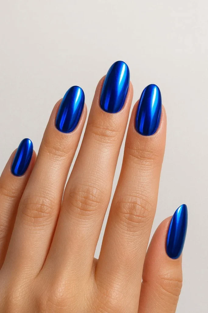 Futuristic metallic blue chrome Y2K nail finish 
