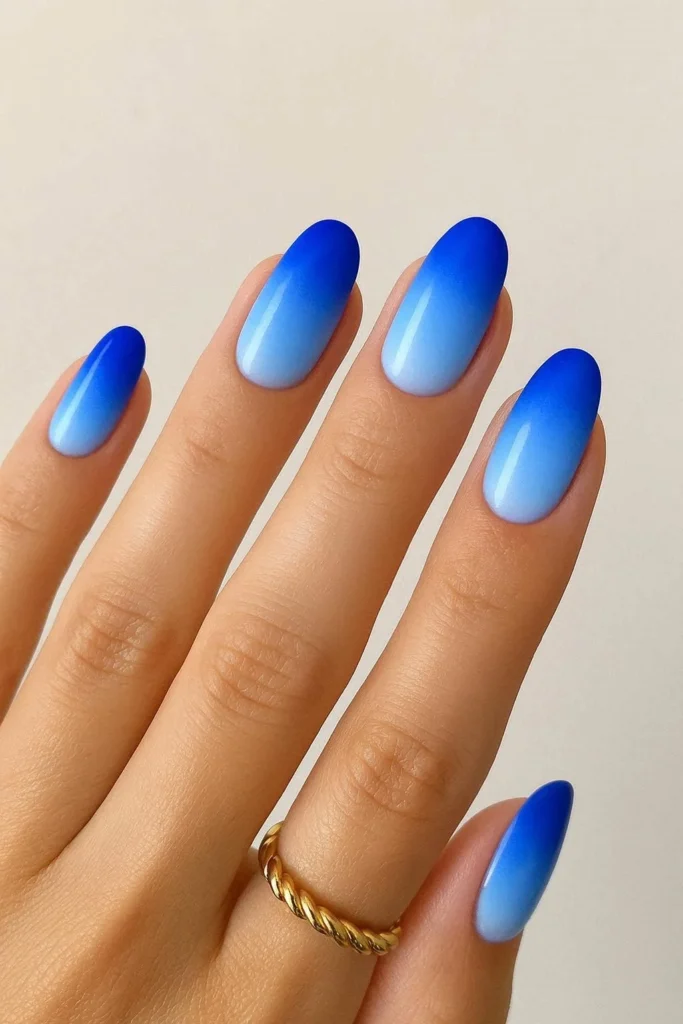 Blue ombre summer nails with soft cobalt to baby blue gradient
