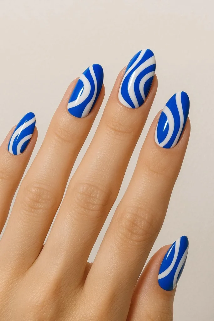 Blue and white abstract nails with crisp retro-inspired swirl art