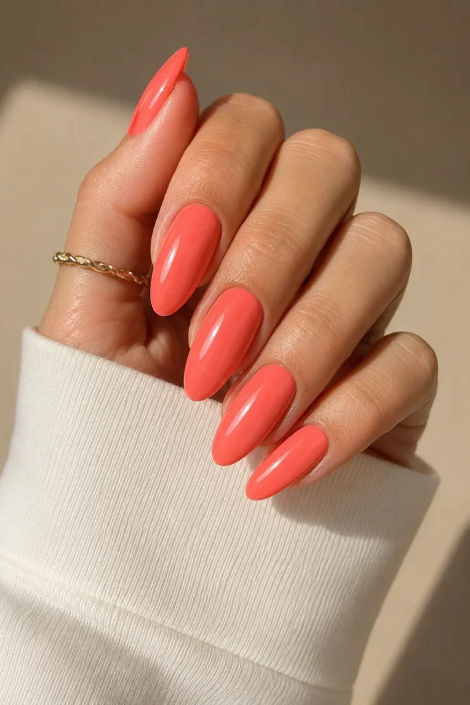 Bright coral almond nails glossy bold summer manicure
