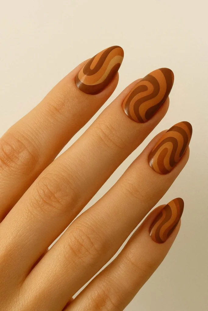 Brown retro swirl nails with earthy 70s-inspired abstract patterns