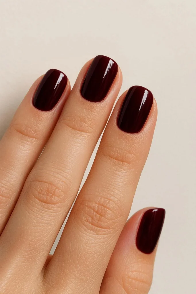 Deep burgundy December nails with rich glossy wine finish