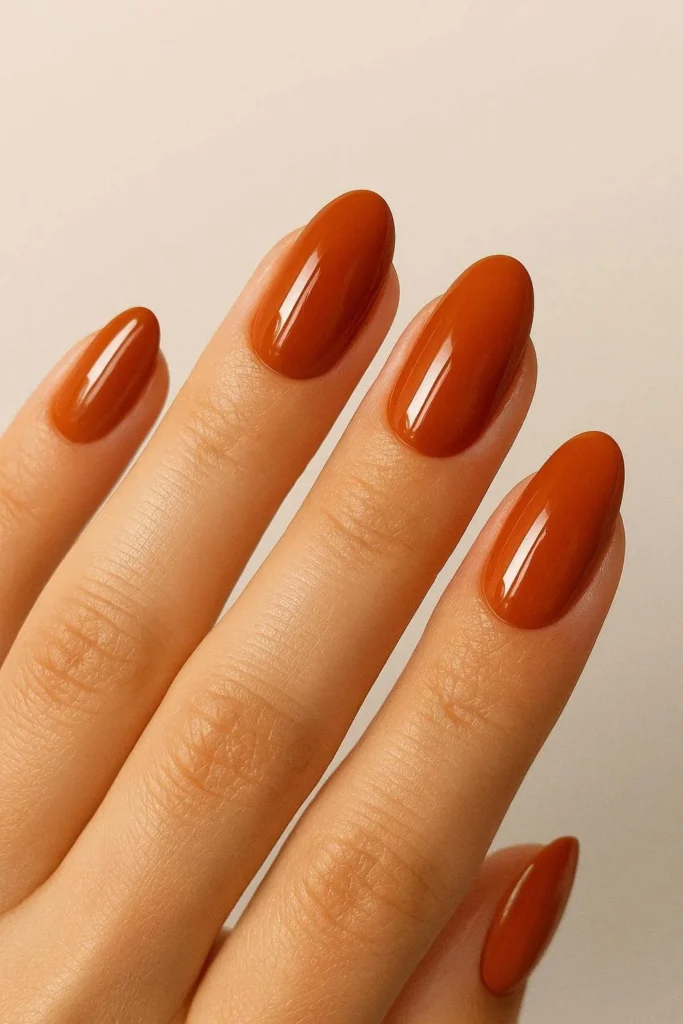 Burnt orange high-gloss nails for October fall manicure