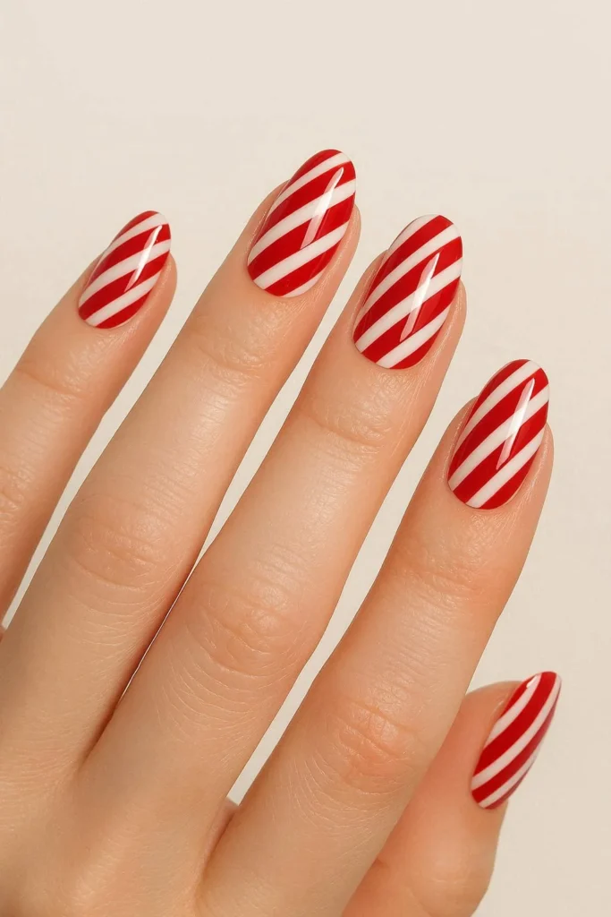 Red and white candy cane stripe nails for holiday season 