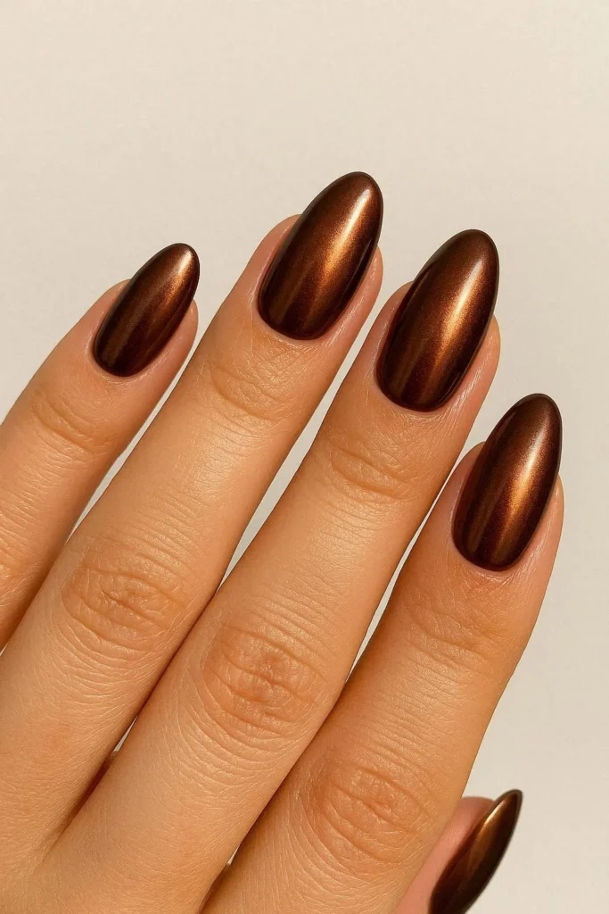 Chocolate chrome nails with warm bronze metallic finish