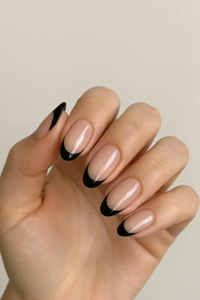 Classic glossy black French tip nails on nude base