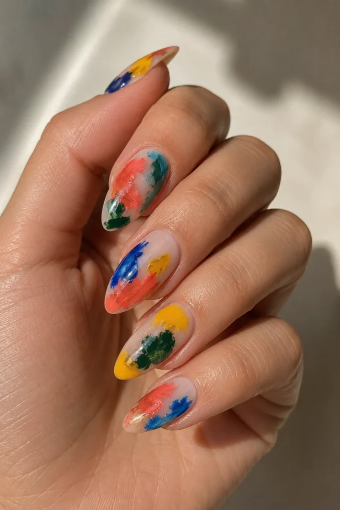 Color splash abstract nails with bold paint strokes on almond shape