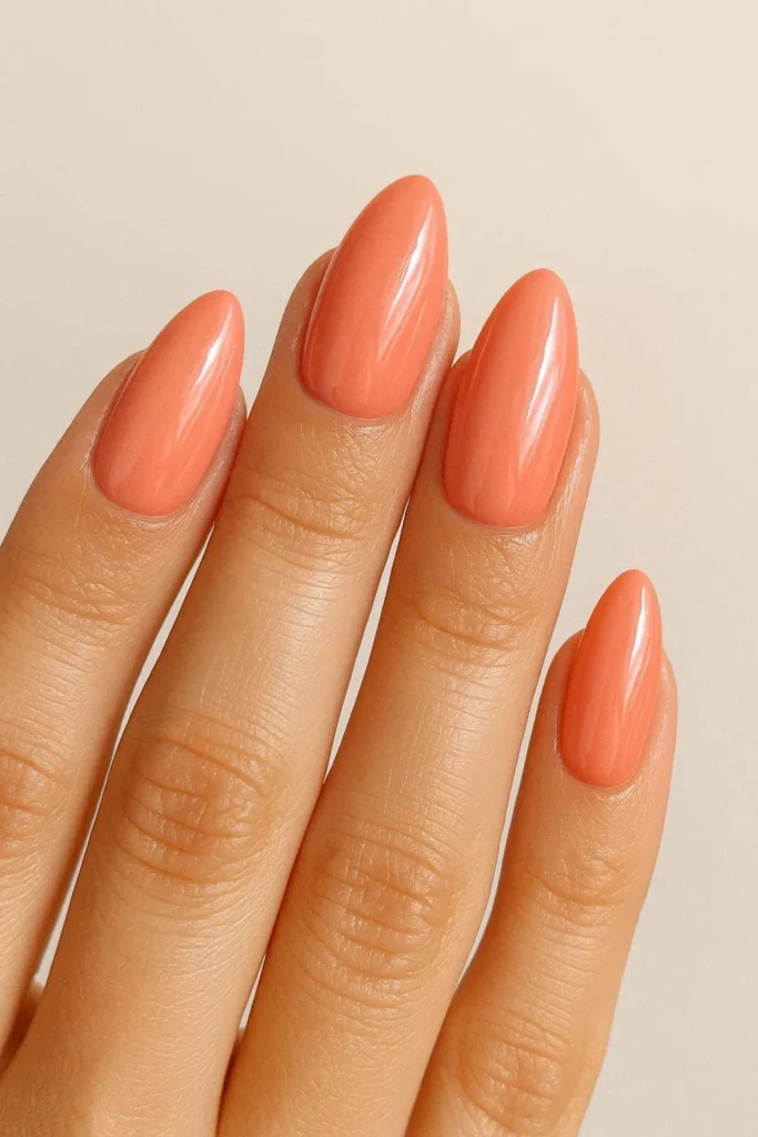 Coral pink almond nails in bright warm sun kissed shades