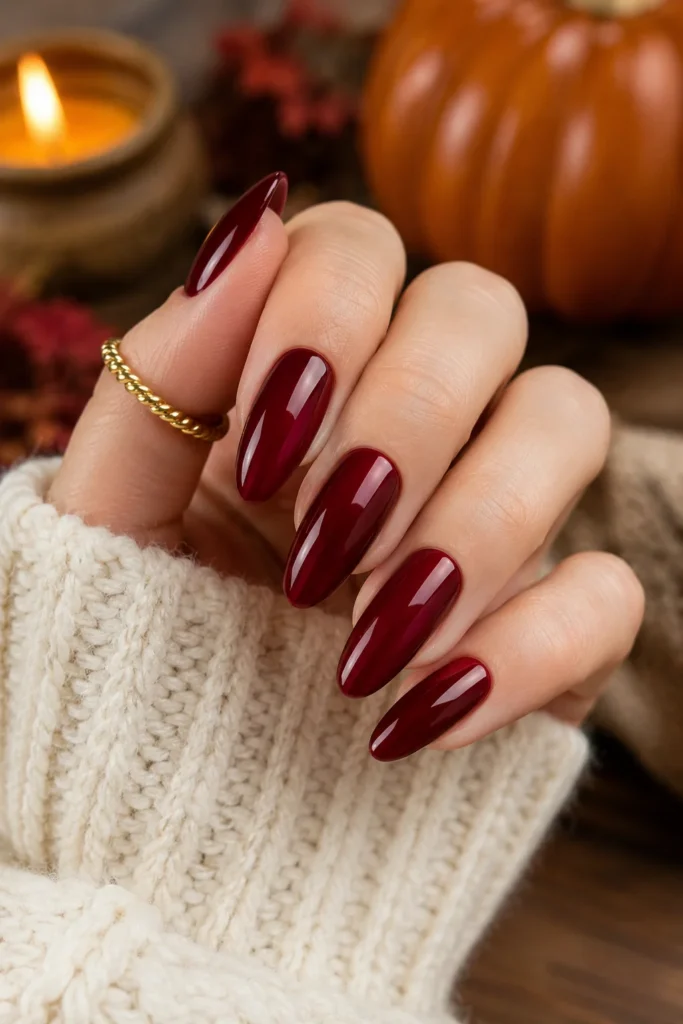 Cranberry red glossy almond nails for chic Thanksgiving manicure
