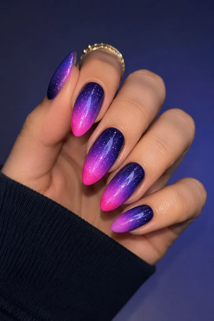 Electric aura nails in purple and blue gradient on almond shape 