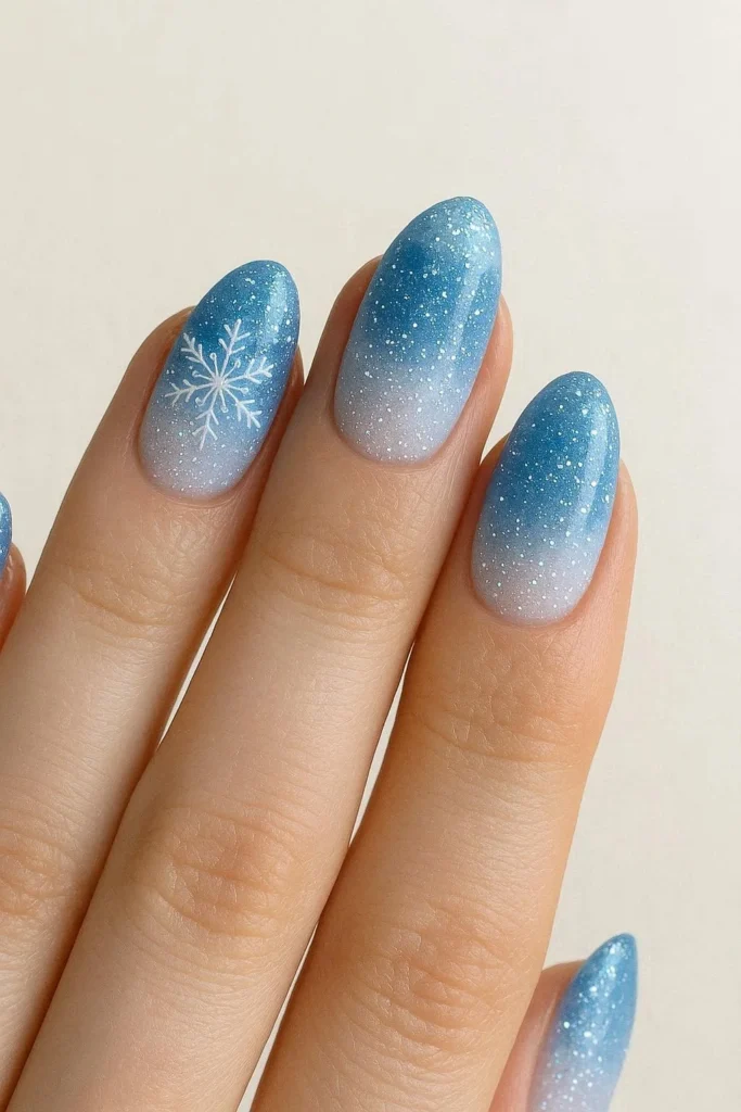 Frozen-inspired icy blue and white glitter winter nails