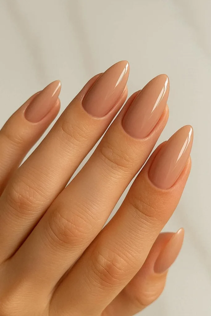 Glossy nude almond shaped engagement nails polished flawless finish