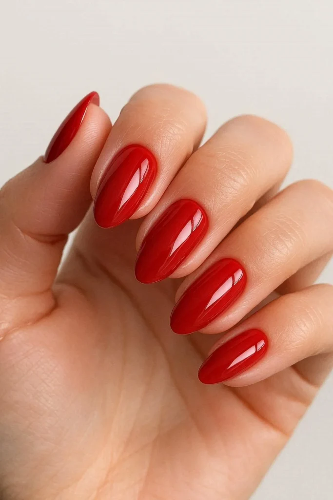 Glossy red graduation nails with timeless bold classic appeal