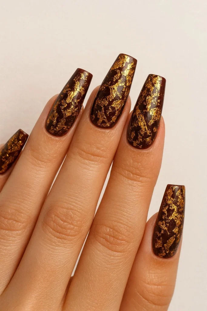 Gold foil autumn nails on dark fall base