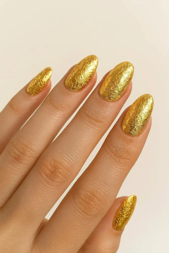 Luxe gold foil festival nails over nude base for Coachella