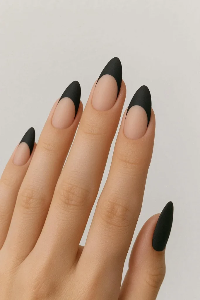 Matte black French tip nails with creamy nude base