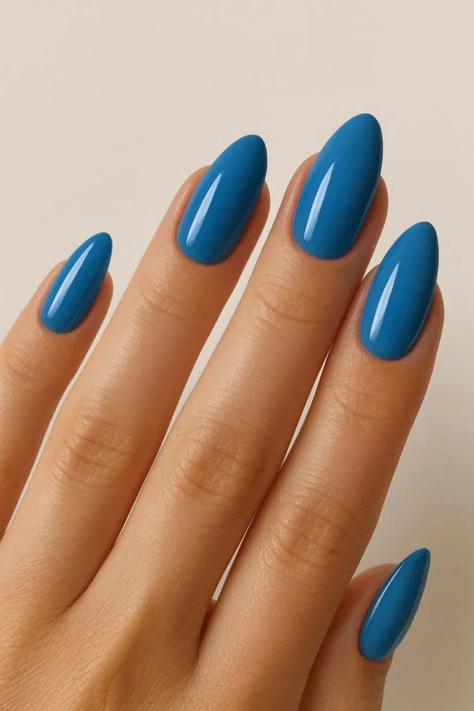 Ocean blue almond nails in deep and light blue sea shades 