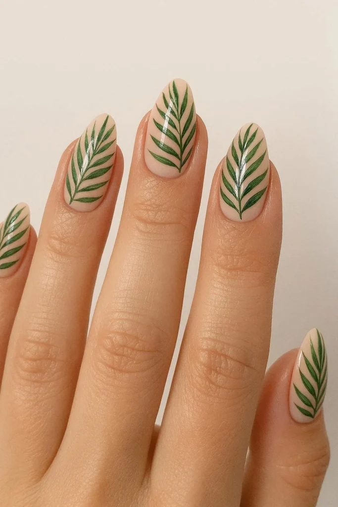 Palm leaf almond nails with green leaves on nude base