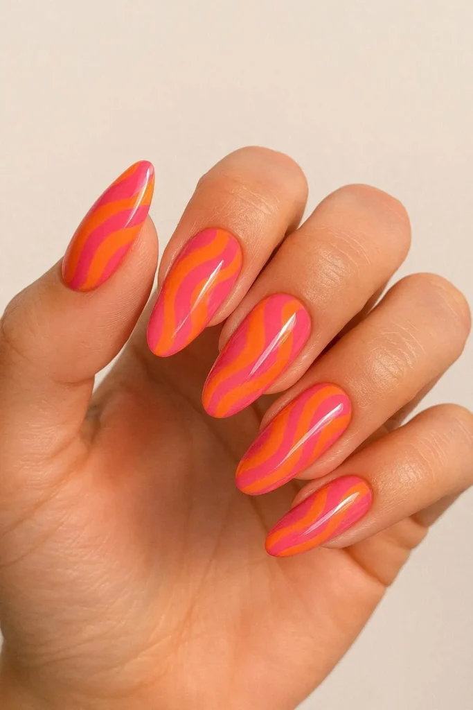 Pink and orange pucci nails with glossy abstract swirl design