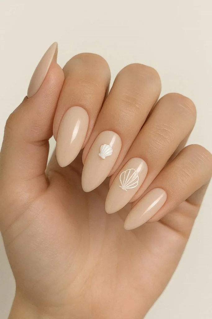 Shell accent almond nails with tiny coastal seashell inspired details
