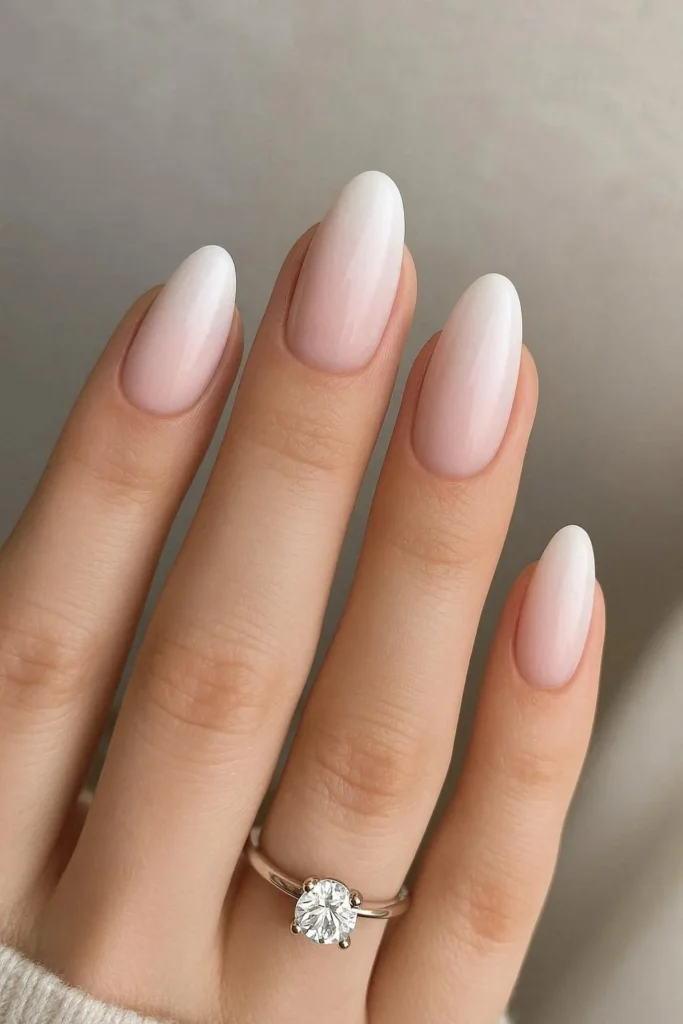 Soft pink to white ombre gradient engagement nail design 