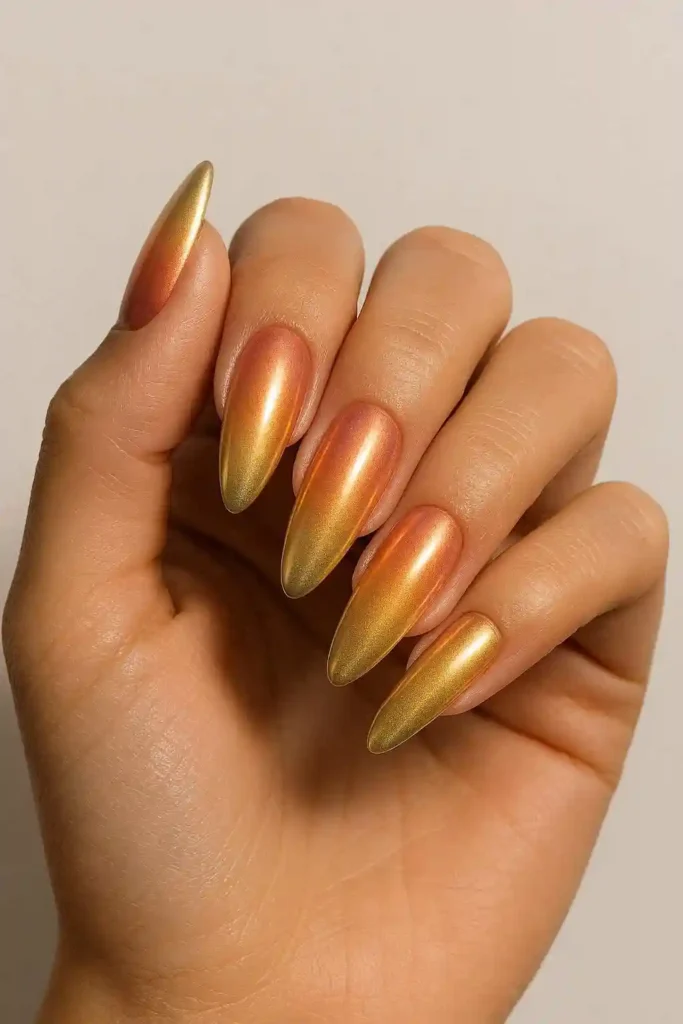 Sunset chrome nails with warm orange gold gradient metallic finish