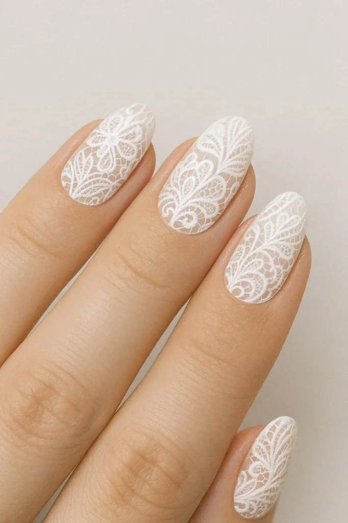 Elegant white lace nail designs on a sheer nude base 