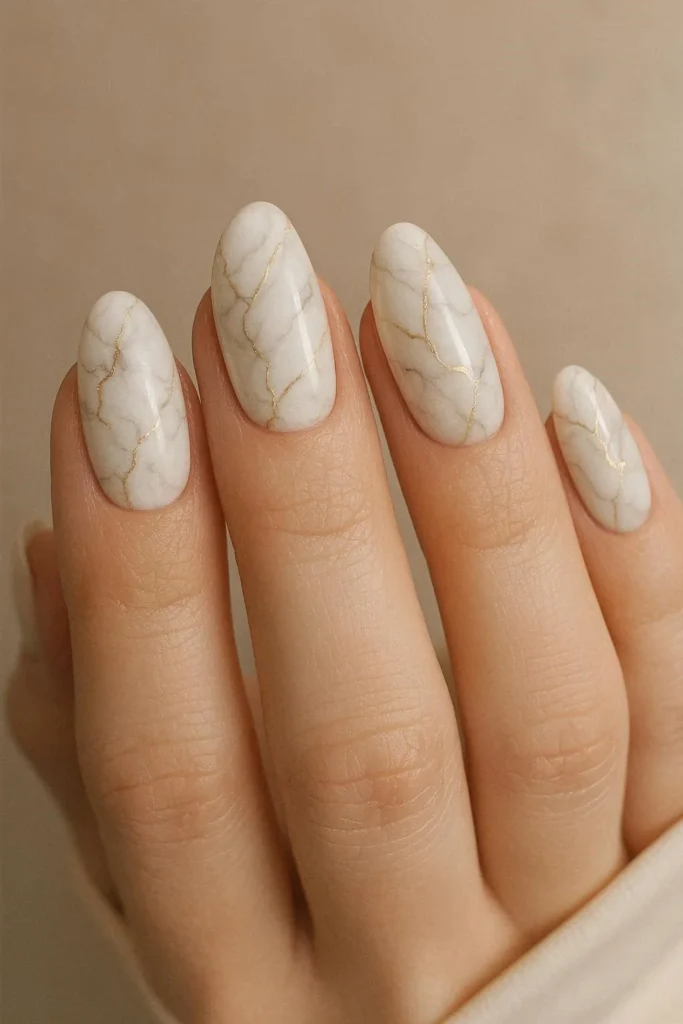 White marble engagement nails with fine gold vein details