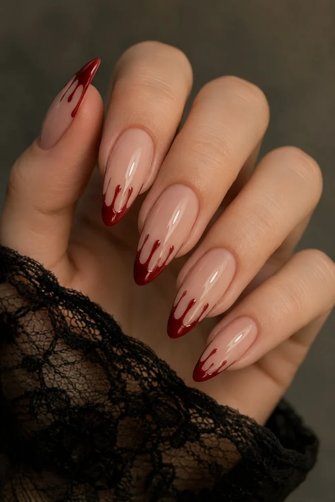 Almond shaped nails with subtle red blood drip tips 