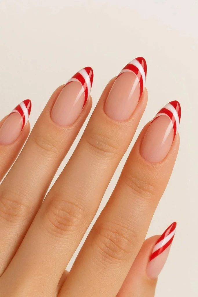 Elegant almond shaped candy cane French tip nails holiday