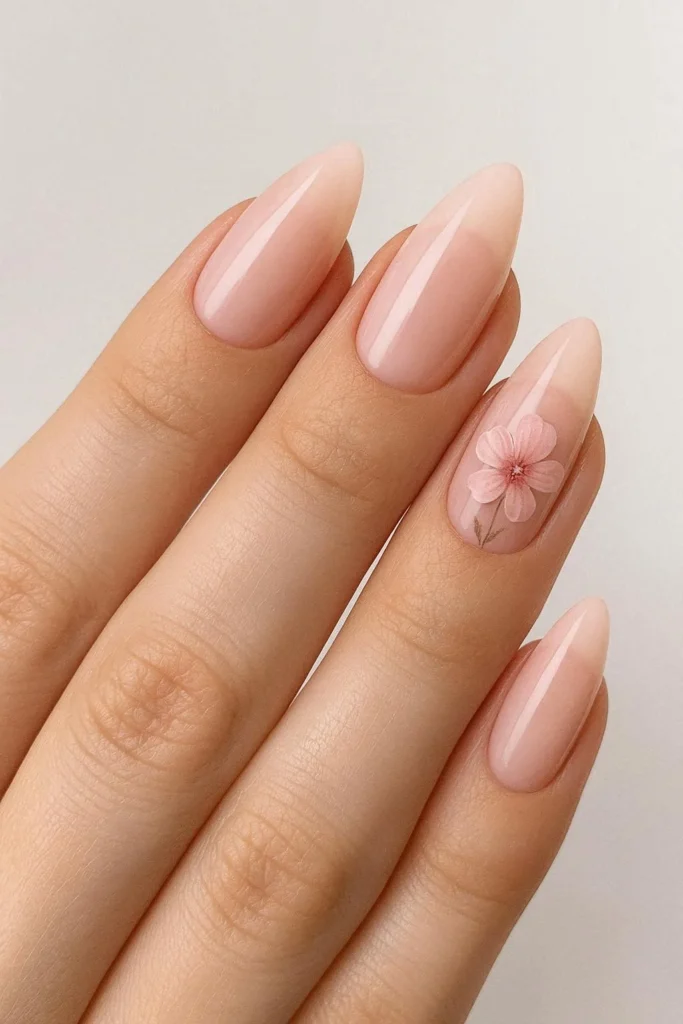 Almond-shaped French nails with soft pink floral accents