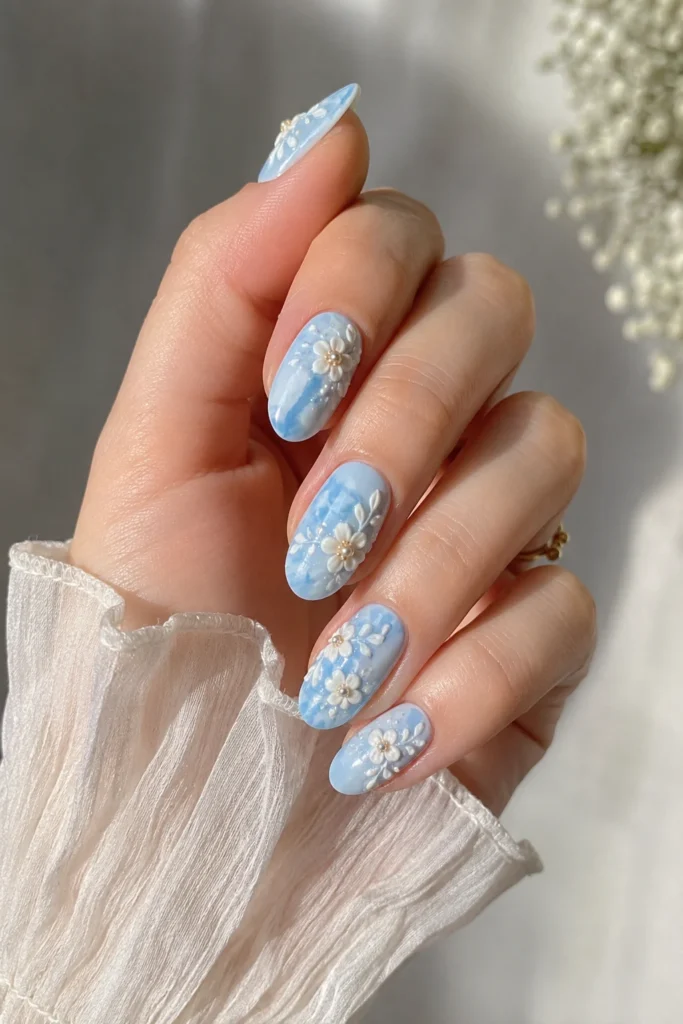 Baby blue floral 3D nails with raised white flower nail art design