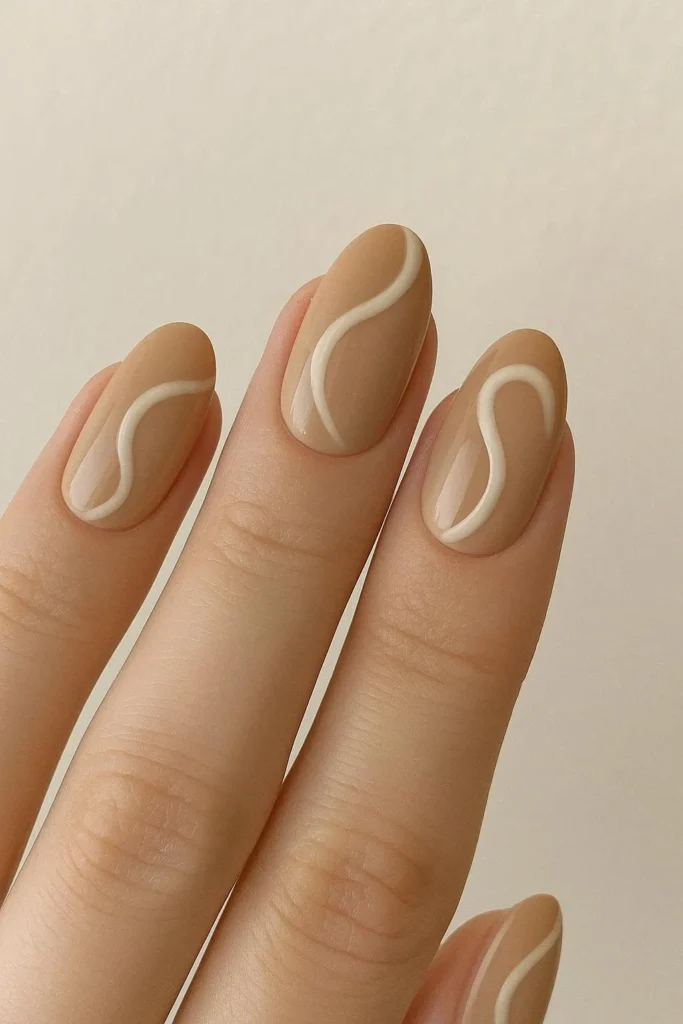 Beige swirl nails with minimal tonal swirl art on neutral base