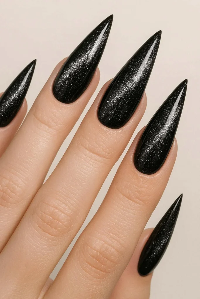  Black diamond cat eye nails with silver shimmer on stiletto shape